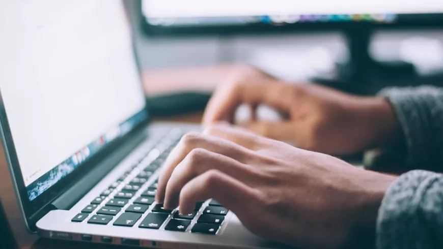 hands typing on computer