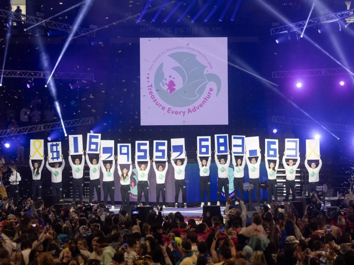 Conclusion of THON with dancers holding up cards signifying the total raised.