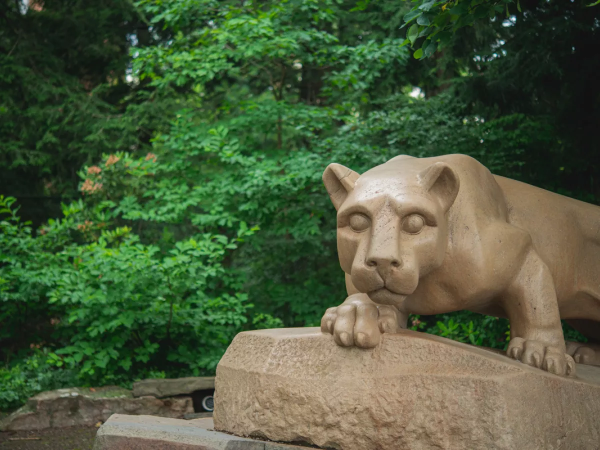 Nittany Lion Shrine with green trees in background