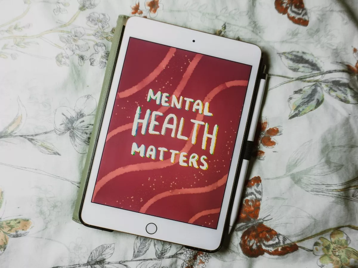 Tablet device with text reading "Mental Health Matters" on screen