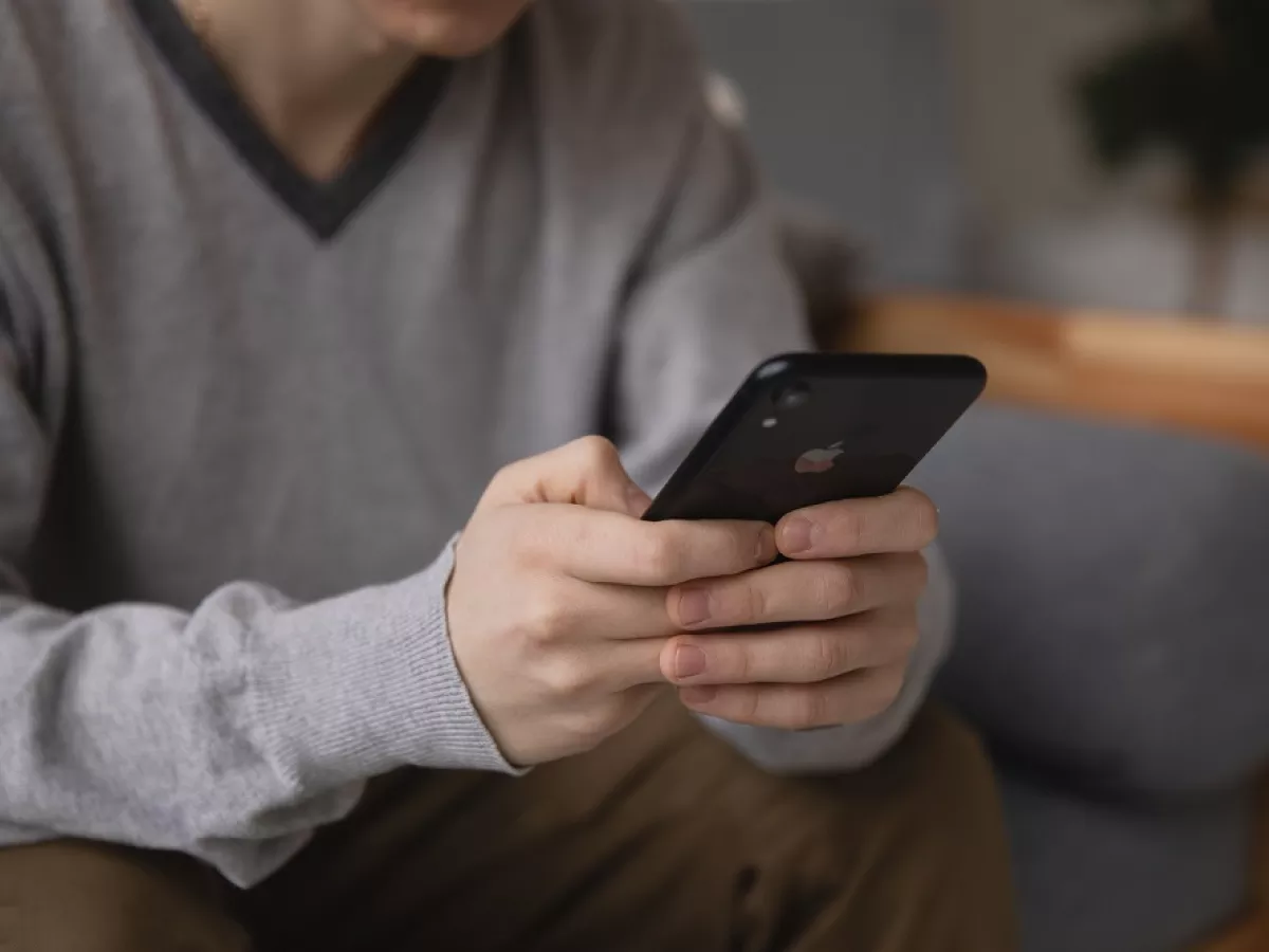 Hands holding cell phone