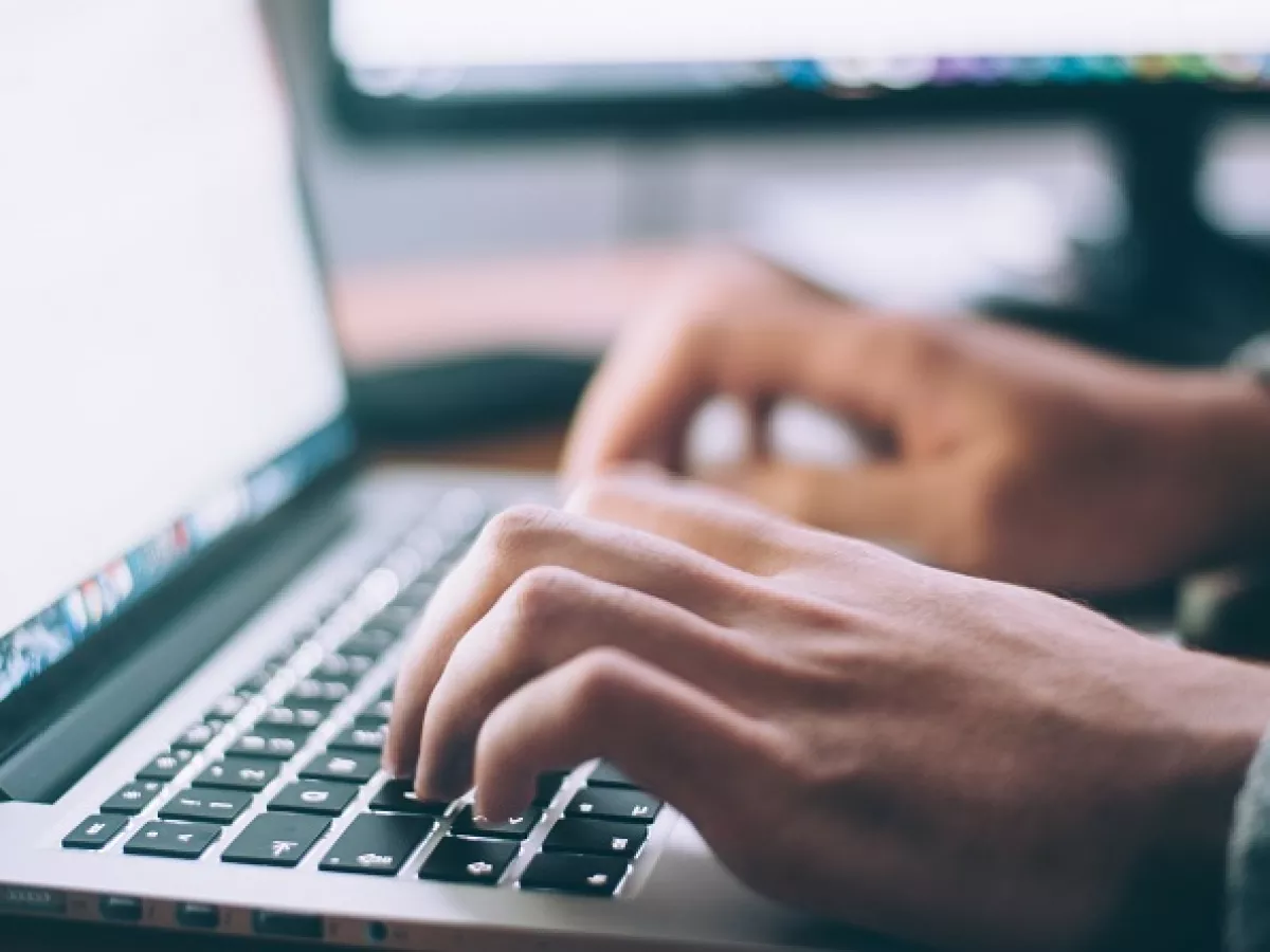 hands typing on computer